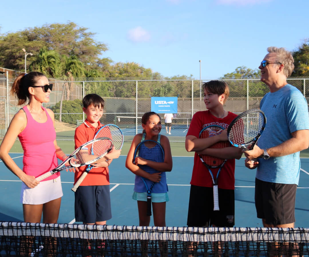 Family playing tennis